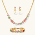 Gold-plated jewelry set with pink, turquoise and red flower-shaped cubic zirconia stones, featuring necklace, earrings and bracelet.