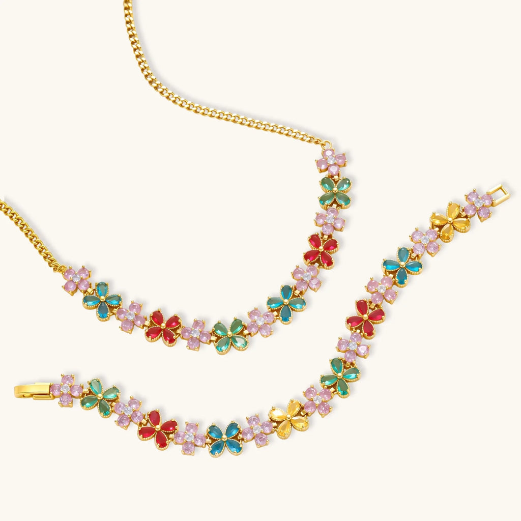 Gold-plated jewelry set with pink, turquoise and red flower-shaped cubic zirconia stones, featuring necklace, earrings and bracelet.