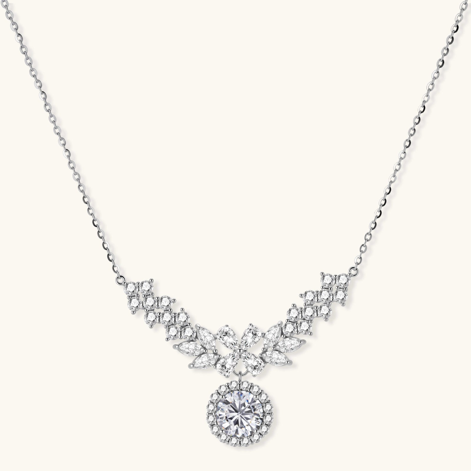 Elegant sterling silver necklace featuring intricate wing-like design with brilliant moissanite stones on neutral background.