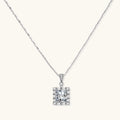 Square moissanite pendant with halo setting on delicate sterling silver chain against white background.