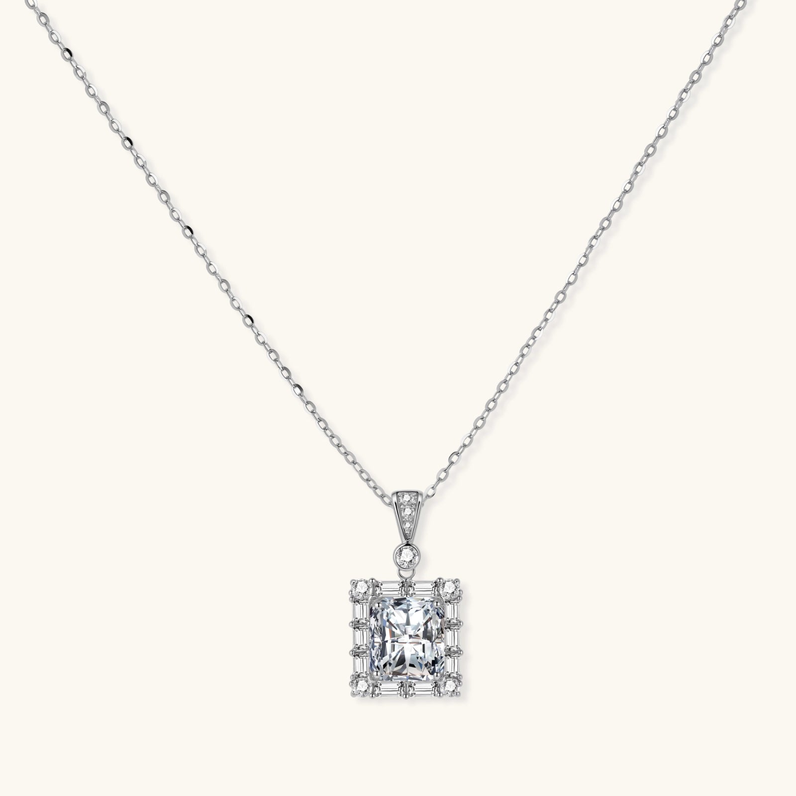 Square moissanite pendant with halo setting on delicate sterling silver chain against white background.