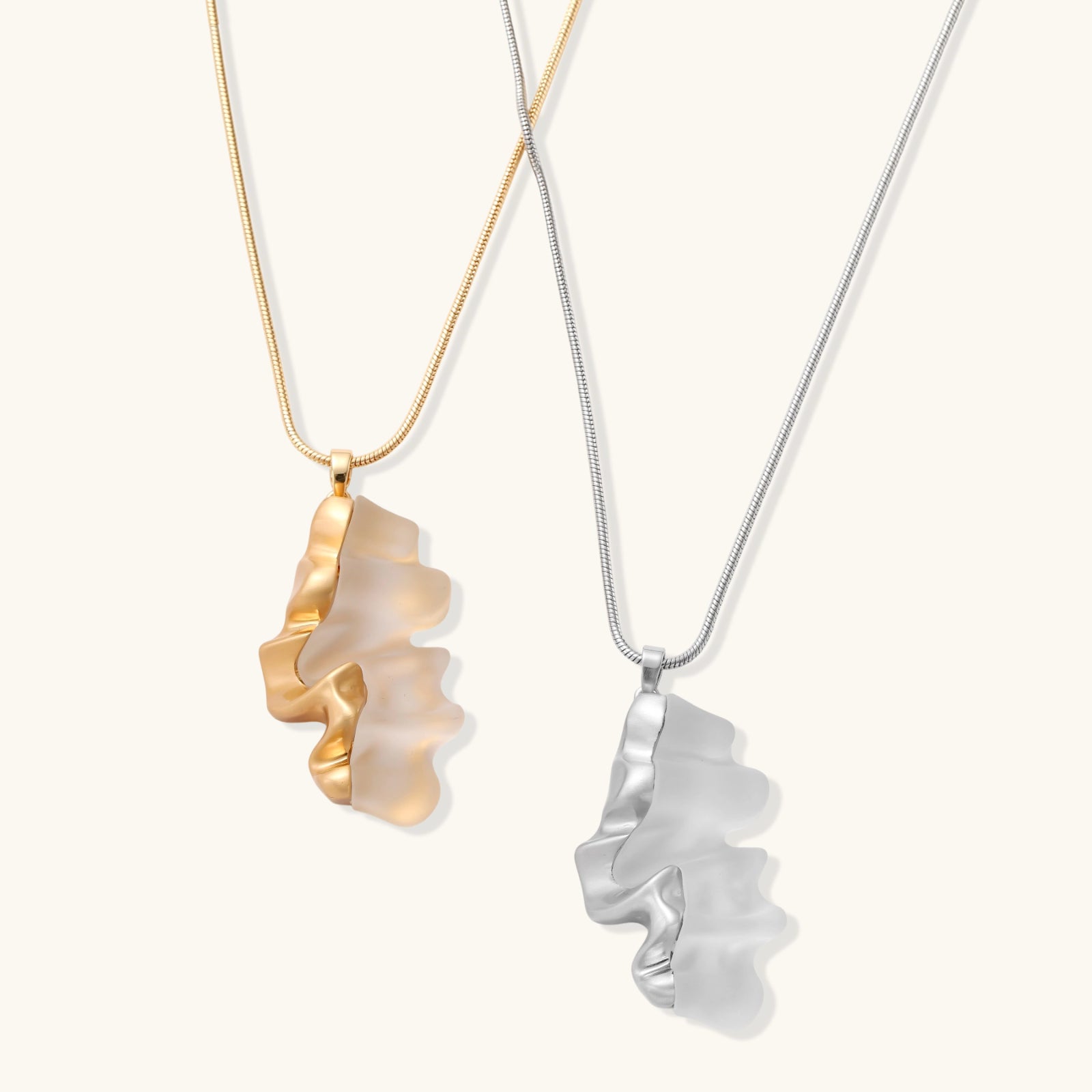 Close-up of a sculptural necklace with flowing wave pendant made from eco-zinc alloy on adjustable chain