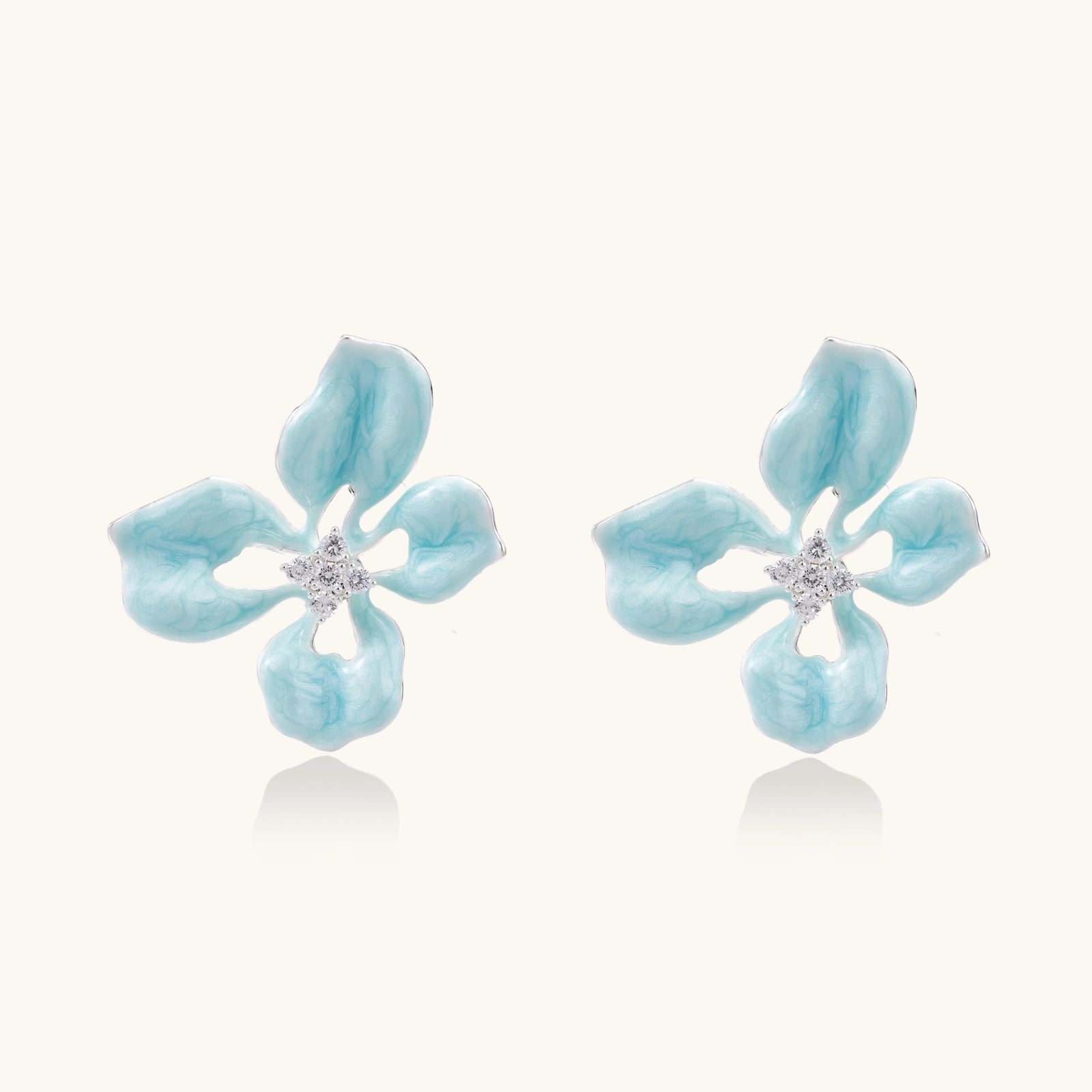 Turquoise enamel flower stud earrings with marbled finish and crystal centers on 18K gold plated brass