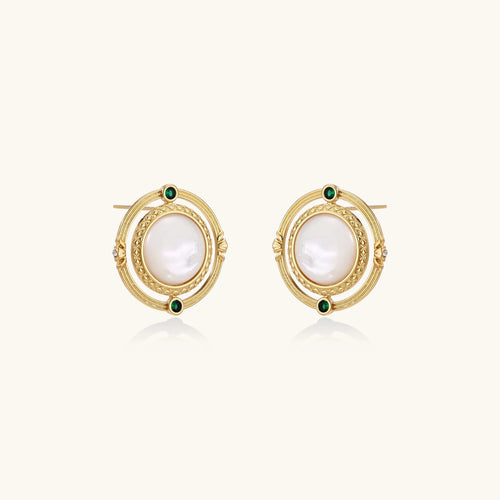 Circular gold stud earrings with iridescent mother-of-pearl center and green zirconia accents on cream background.