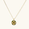 Gold-plated pendant necklace with green enamel background and oval olive cubic zirconia center stone with crystal accents.